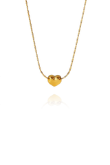 A slim chain with a gold heart shape pendant on display without background