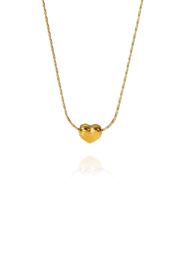 A slim chain with a gold heart shape pendant on display without background
