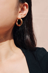 黑色上衣女生配戴金色個性款圈圈耳環打造獨特的率性穿搭風格