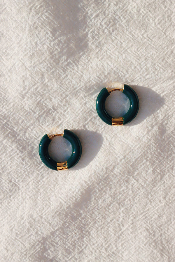Beautiful dark green fashion hoops under the sun.