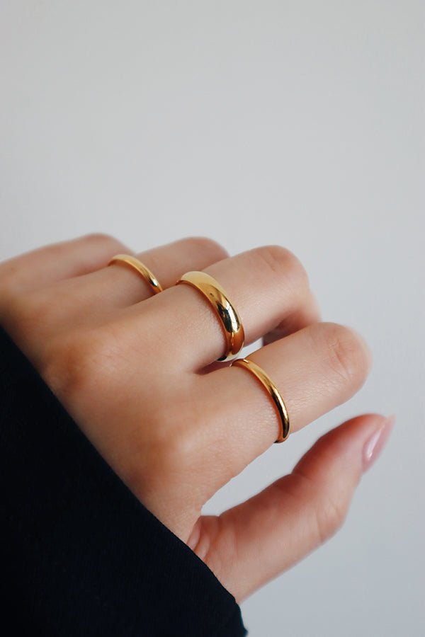 Woman showing her ring stacking look to the camera.