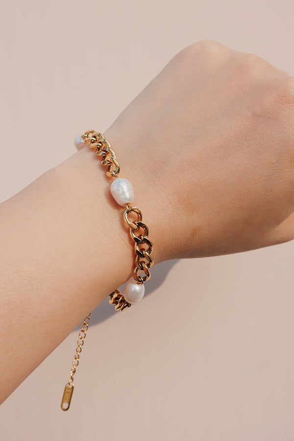 Model showing the freshwater pearl cuban bracelet to camera