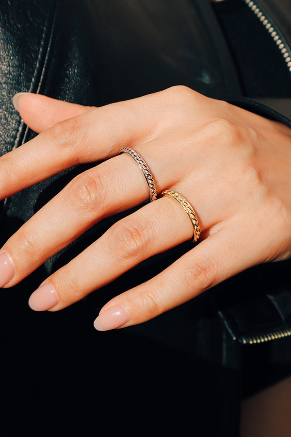Woman style her look with gold and silver color rings.