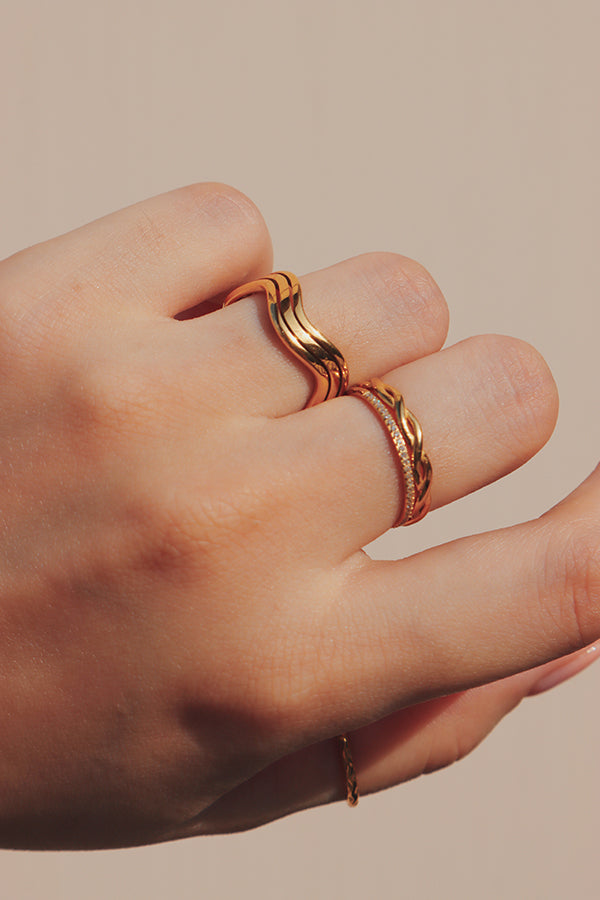 Woman gold weave ring inspired by ocean waves.
