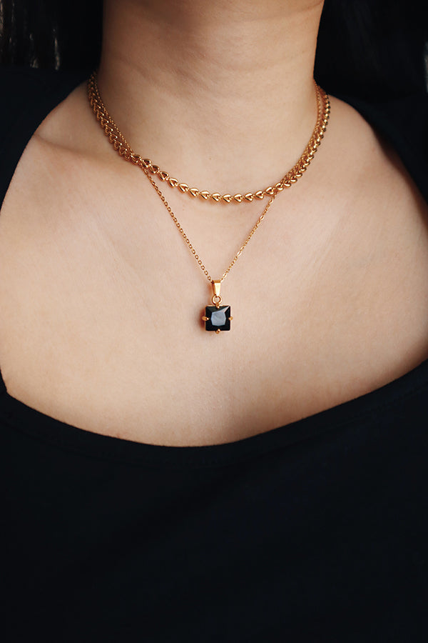 Girl layering tarnish free and hypoallergenic necklaces for her night out look.