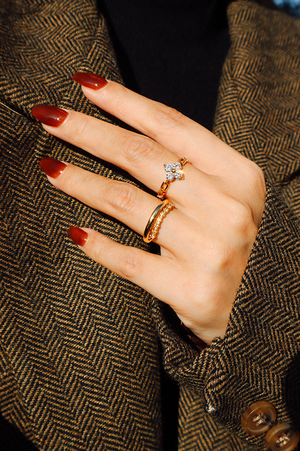 Close-up of 18K gold plated flower ring crafted from hypoallergenic stainless steel, featuring four sparkling zircon petals.
