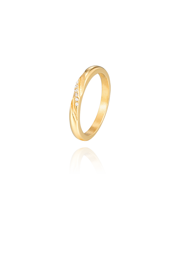 A close-up view of a slim, gold ring with engraved CZ stones along a delicate curve, showcasing its refined texture and minimalistic design.