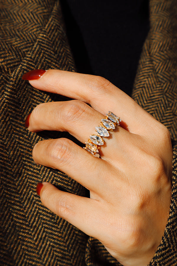 Detailed view of a gold marquise cut crystal ring with dimensional settings creating a luxurious shine.