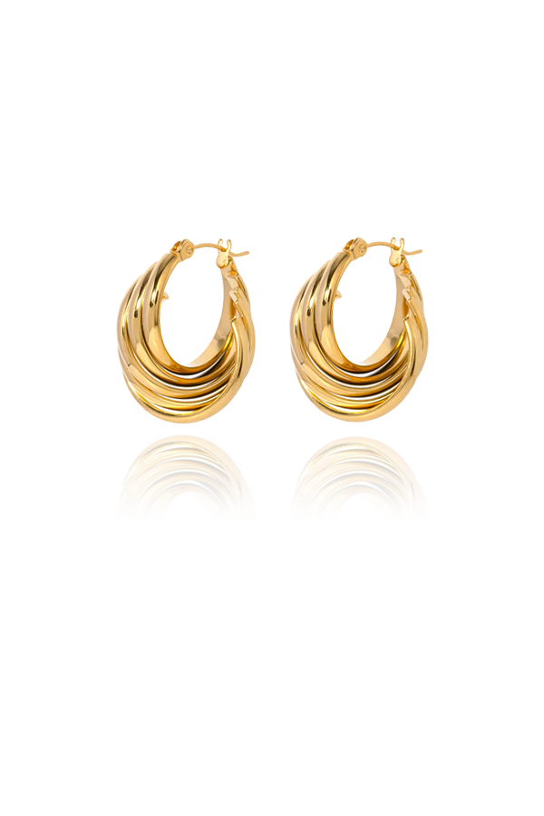 A pair of shell like gold hoops without background on display
