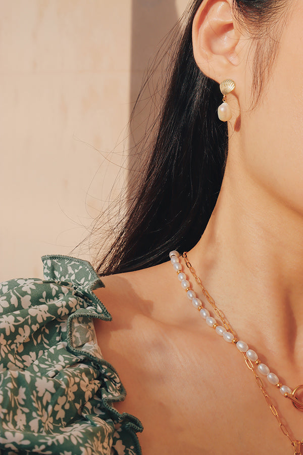 Freshwater pearl drop earrings enhancing summer style.