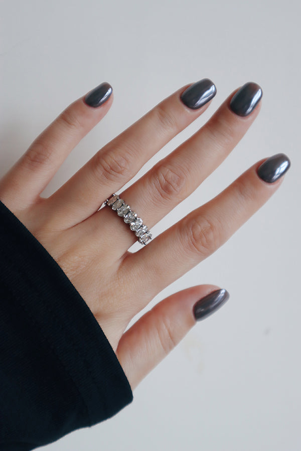 Silver crystal band ring styled with a minimalist outfit, offering subtle shine with strong presence.