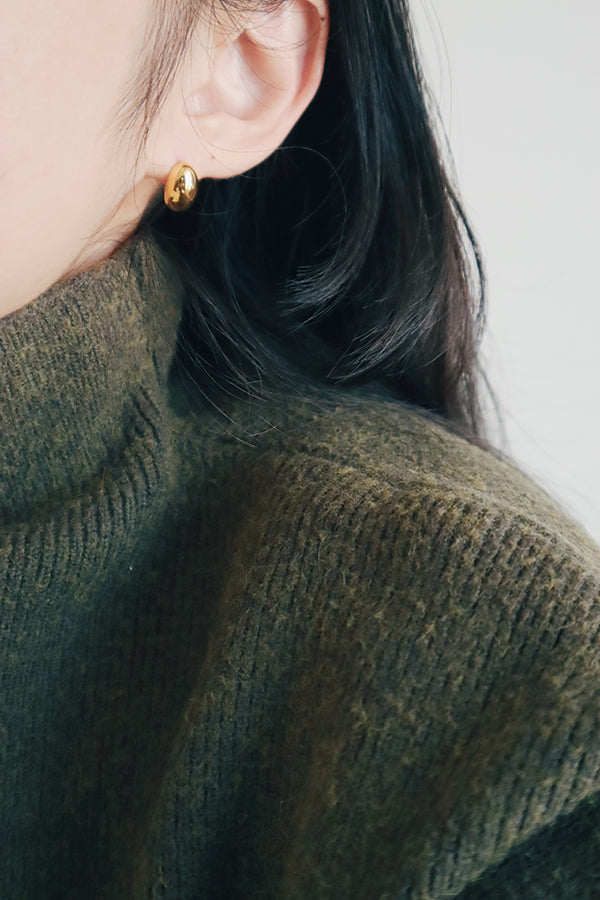 Black hair girl wearing classic and simple oval studs.