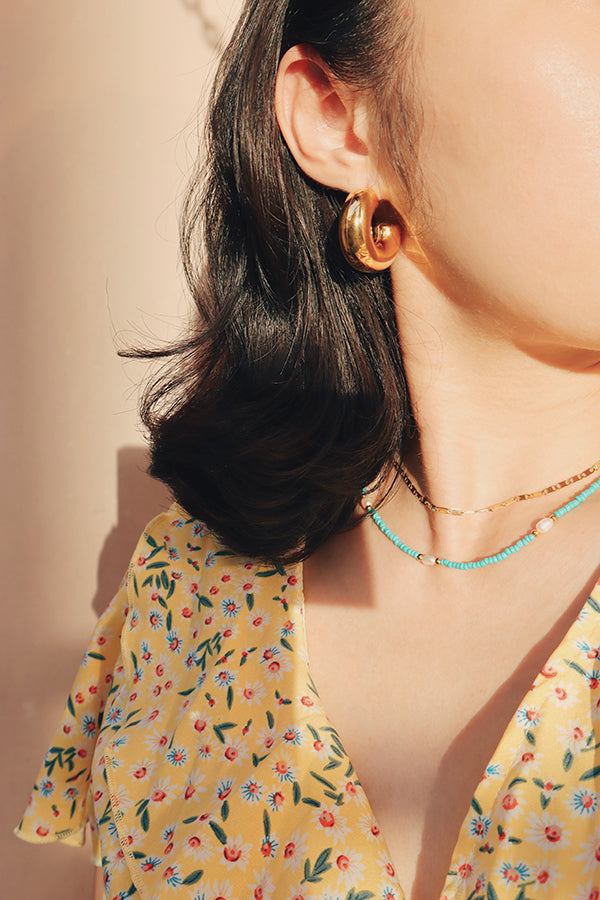 Versatile gold Janel Thick Hoops, ideal for vacation, a night out, or a casual day.