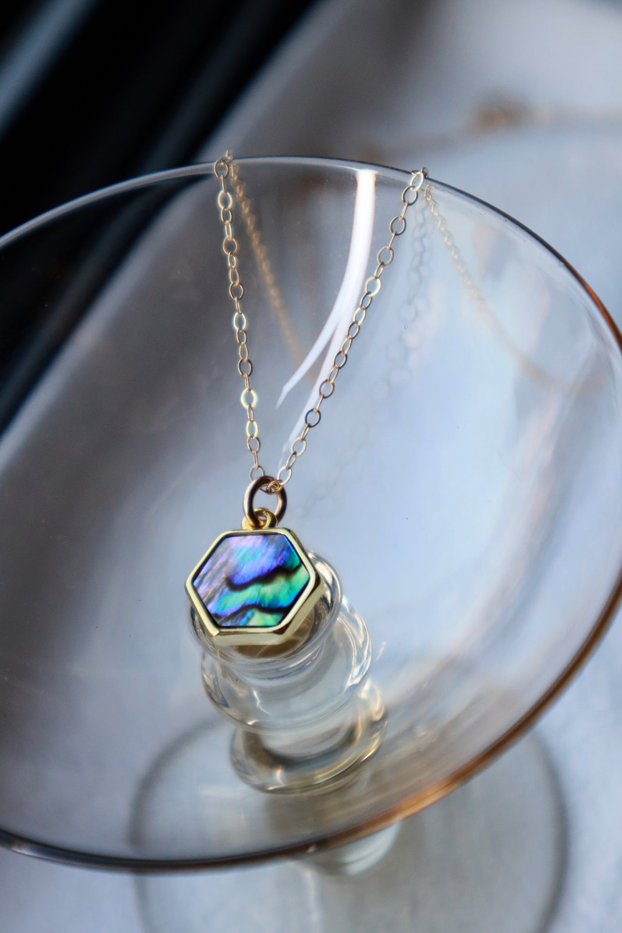 Hexagon abalone necklace in a small glass
