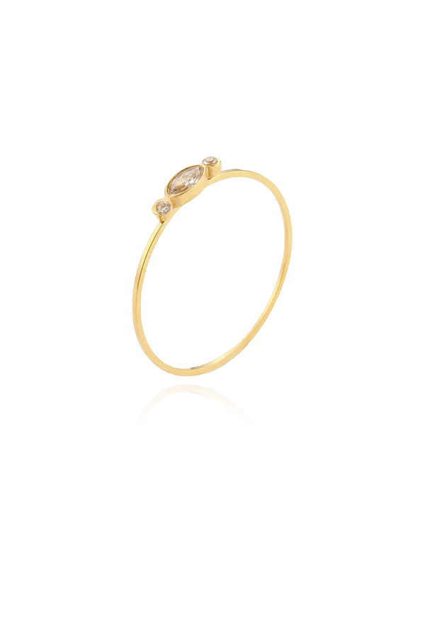 A single slim gold ring with a marquise-shaped clear cubic zirconia stone in the center, flanked by two smaller round stones, shown without background.
