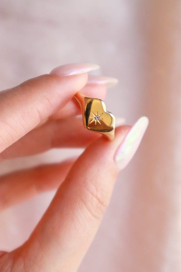 Female holding the stainless steel gold ring
