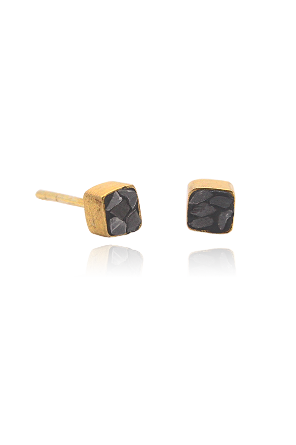 A standalone image of four gold-toned square stud earrings, each featuring a crushed black diamond or stone inlay. The earrings are displayed in a grid pattern on a black background with reflections below.