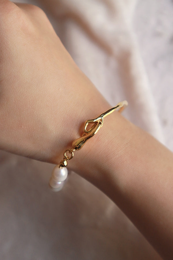 Woman shows the details of the bracelet to camera