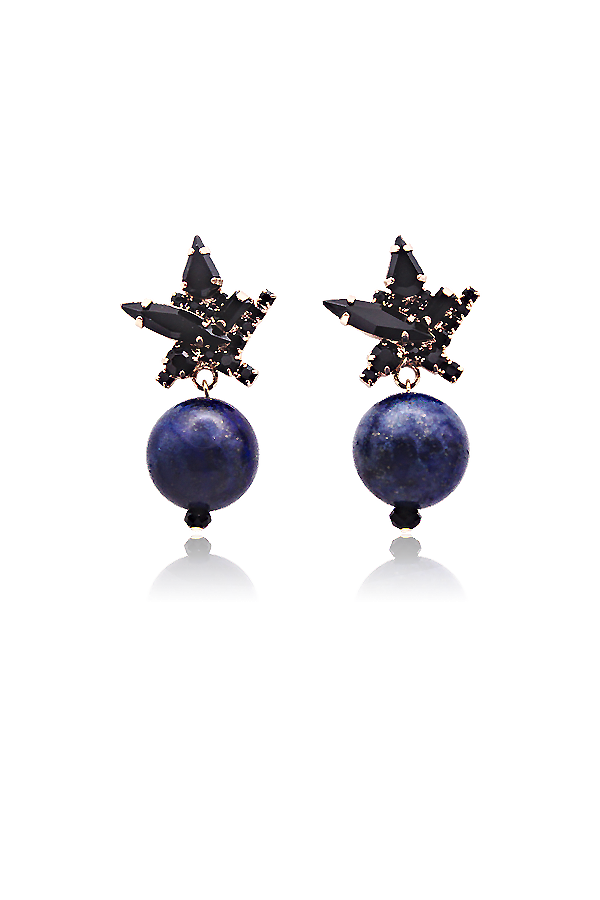 A standalone image of a pair of elaborate gold and black earrings. Each earring features a black starburst design adorned with dark gemstones, from which hangs a round, deep blue lapis lazuli stone. The earrings are displayed on a black background with reflections below.