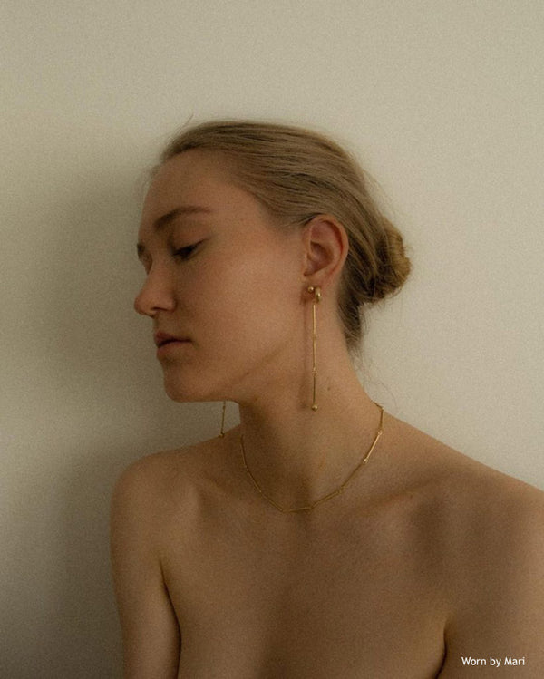 Caucasian half naked female wearing Inga link earrings