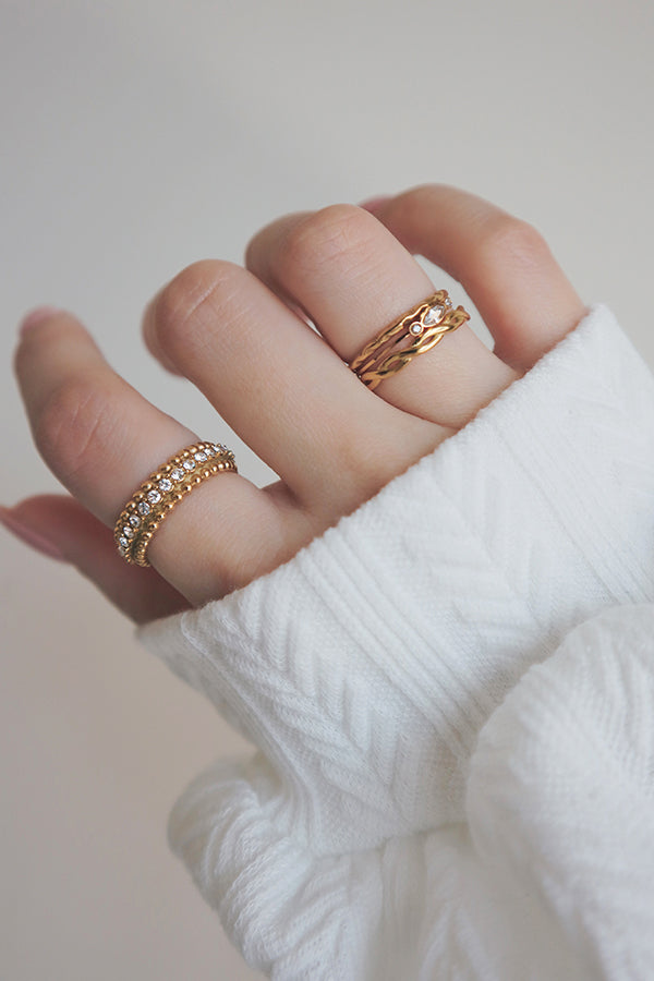 Elegant gold-plated ring featuring shimmering cubic zirconia stones for a touch of glamour.