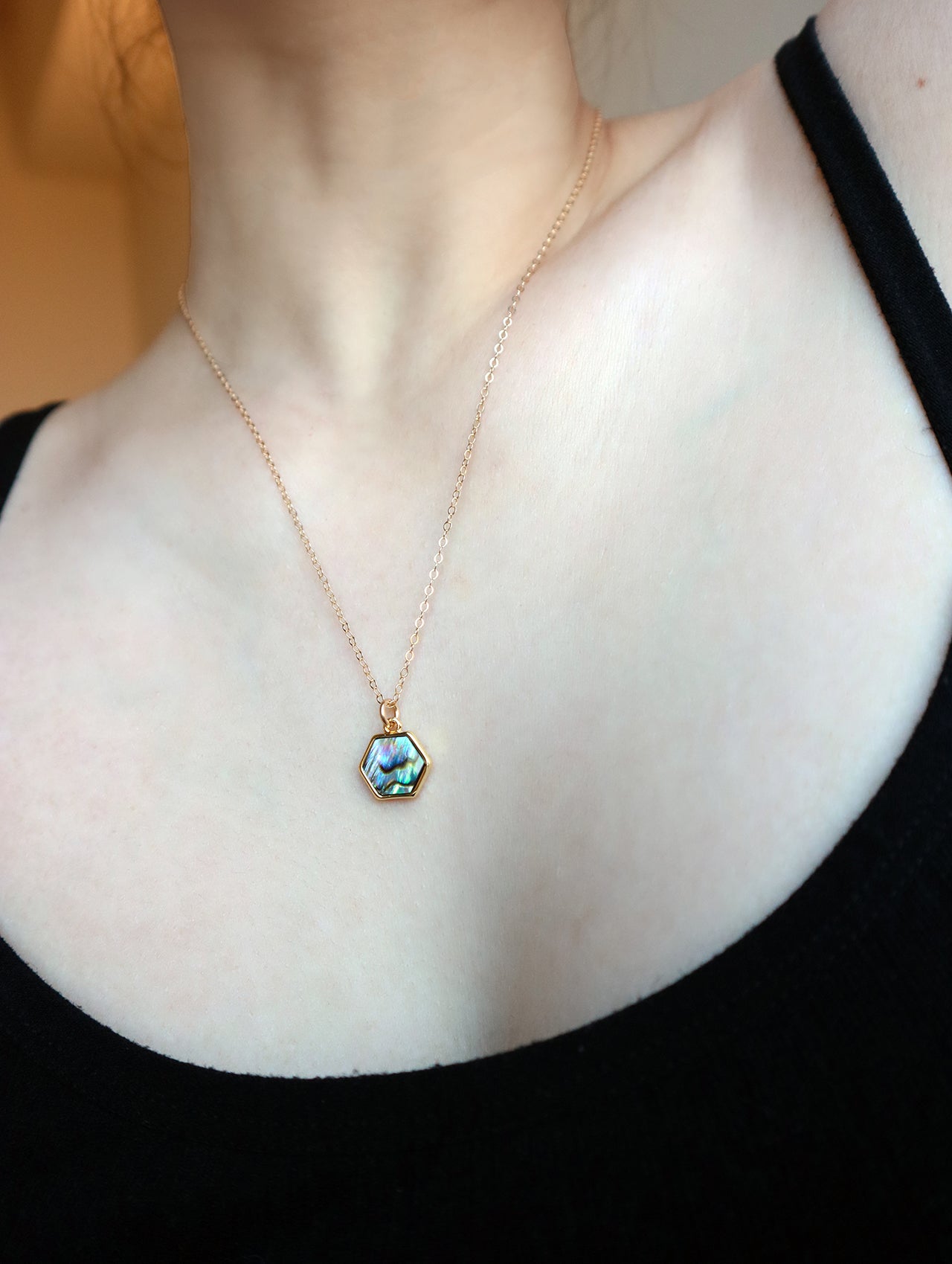 Model wearing hexagon necklace showing neck