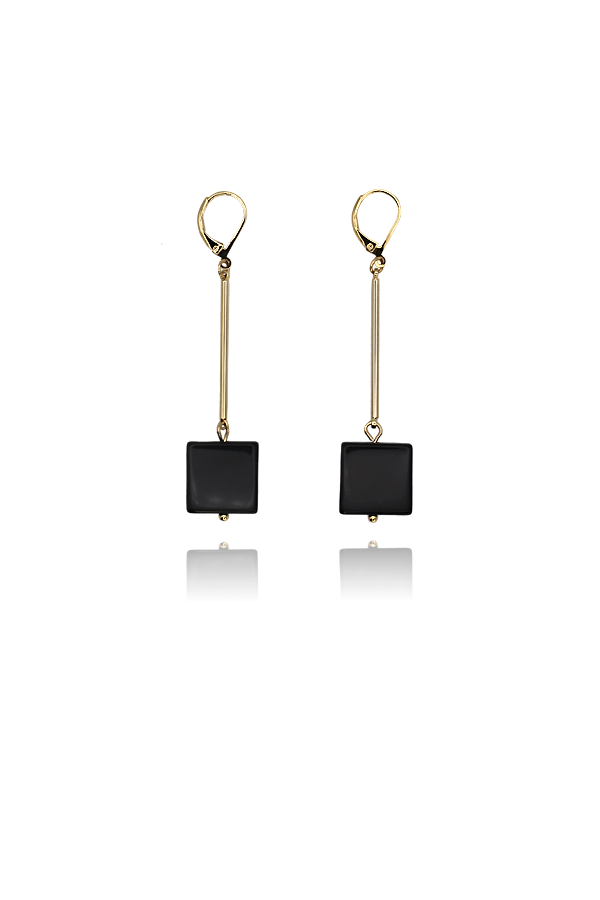 A standalone image of a pair of long, dangling gold earrings with lever-back closures. Each earring features a thin gold bar suspended from the closure, connected to a flat, square black onyx stone, with a small gold bead below the onyx.