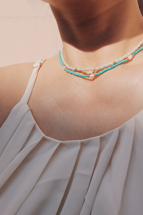 Woman showing off layered necklaces with the Ciera Boho Bead Choker as a centerpiece