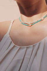 Woman showing off layered necklaces with the Ciera Boho Bead Choker as a centerpiece
