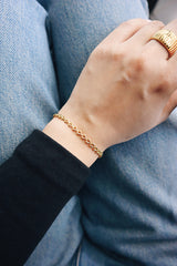 Woman wearing water resistant 18k gold plated dainty bracelet