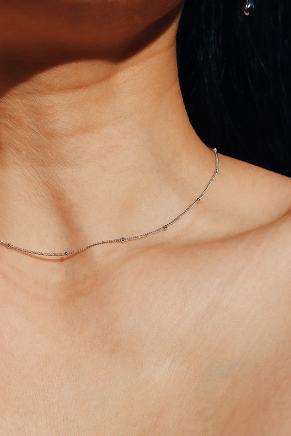Elegant girl wearing dainty round beads necklace for her everyday look