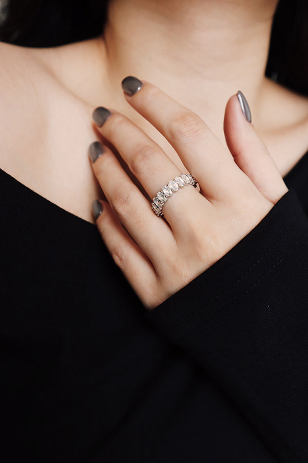 Elegant silver crystal eternity band ring styled with a black top, perfect as a versatile everyday jewelry piece.
