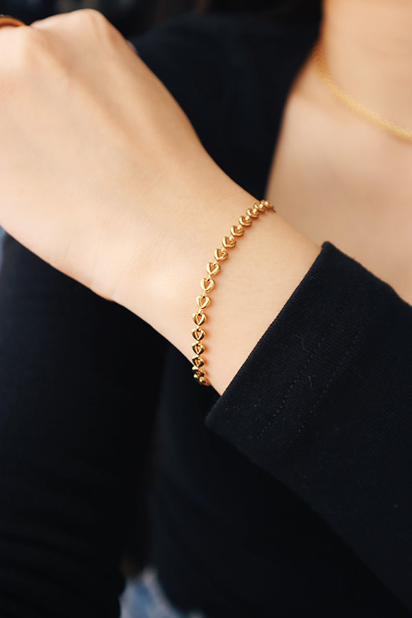 Woman wearing trendy gold chain bracelet for her office outfit