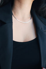Office woman wearing waterproof silver herringbone chain choker
