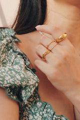 Girl in dress stack waterproof gold rings for her summer look