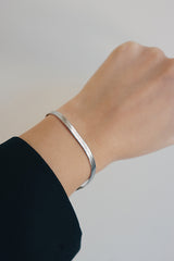 Office woman wearing stainless steel hypoallergenic silver color bracelet jewelry
