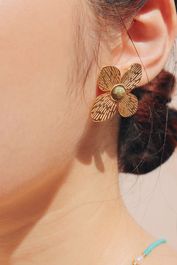 Modle showing new trends hypoallergenic gold plated earrings to camera