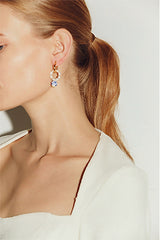 Side profile of European model wearing orient earrings
