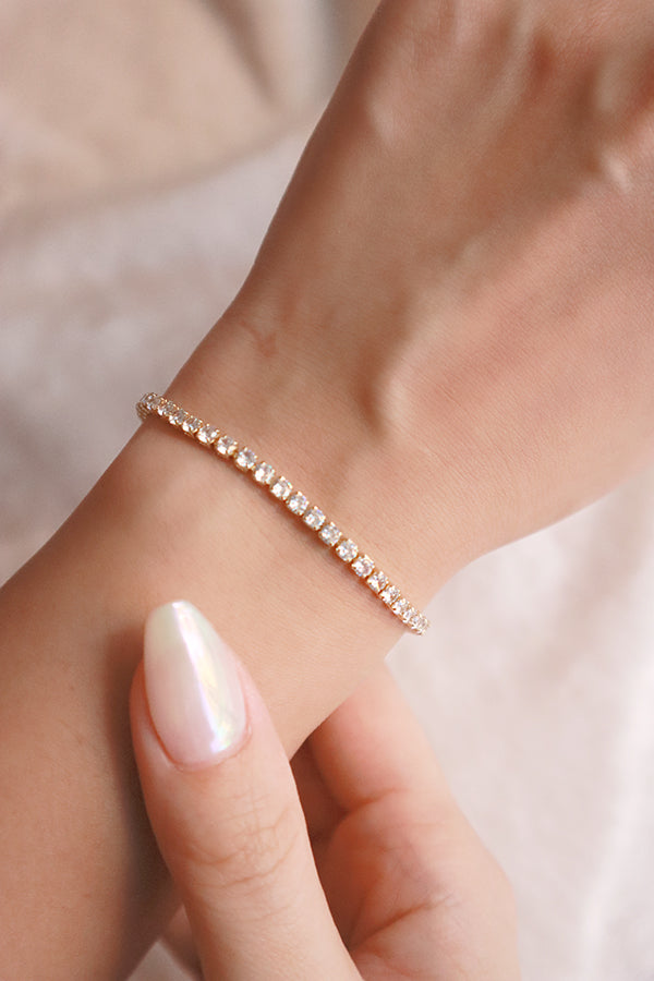 Woman wearing tennis bracelet on her left hand