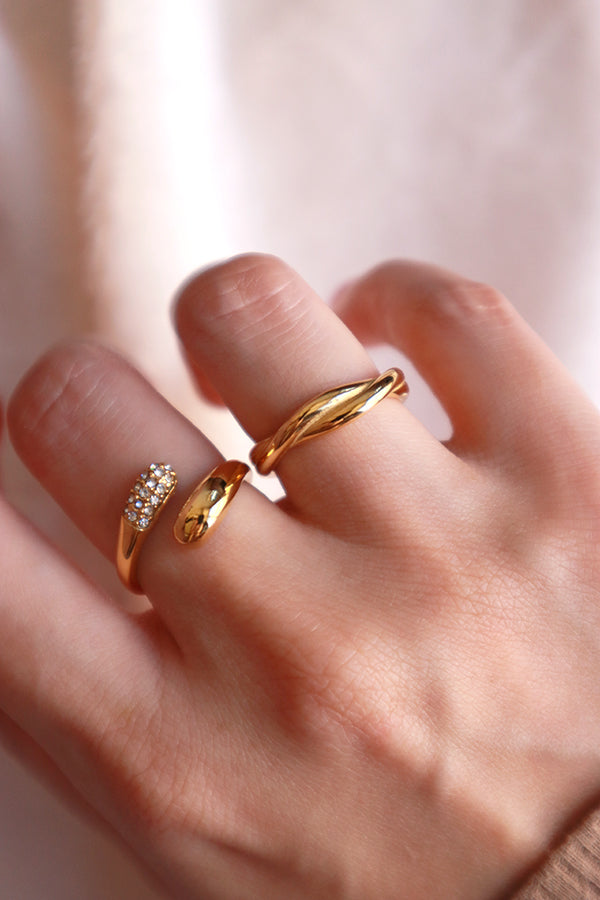 Woman stacking two gold rings on finger