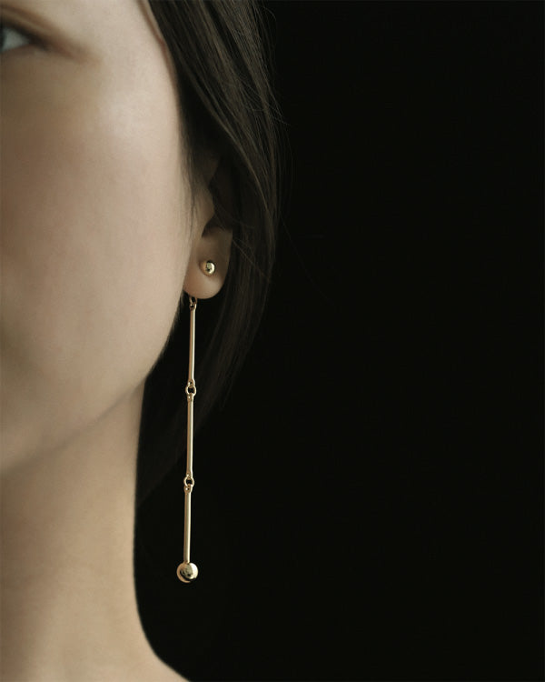 Left half of the face of a asian girl with SH & Co.'s linked earrings
