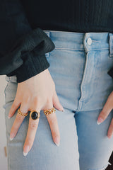 Woman use gold gemstone jewelry to create daily outfit look