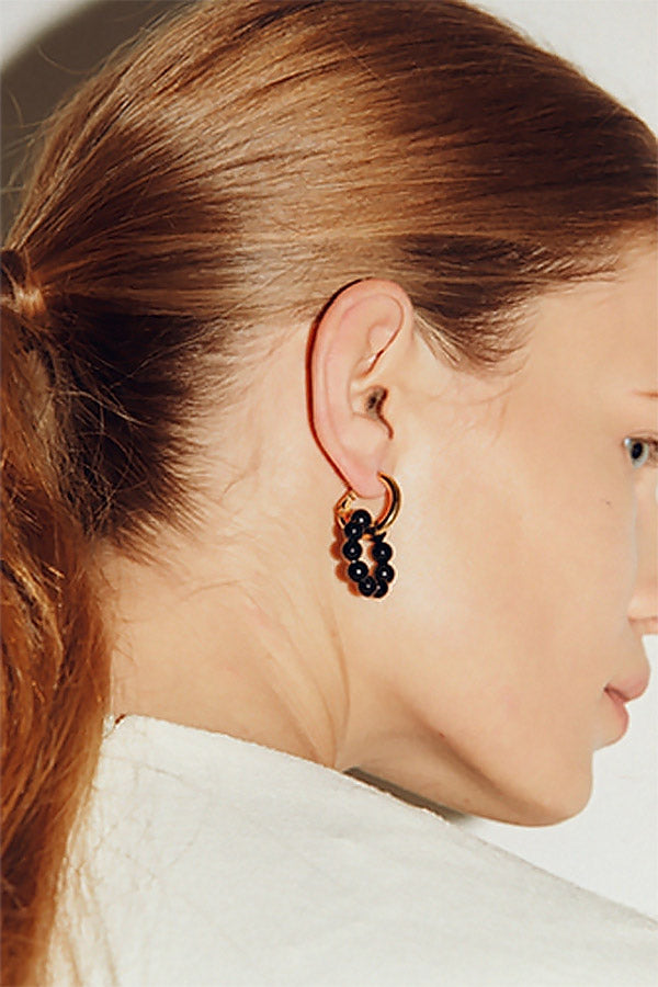 Back shot of girl with black onyx circle earrings