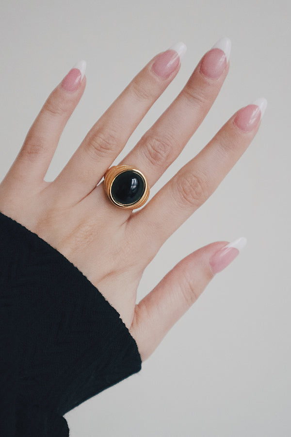 Model in black dress wearing tarnish free gold plated jewelry 