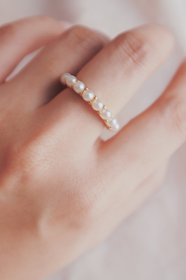 Woman wearing a dainty freshwater pearl ring 
