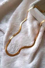 Trendy gold snake necklace in the jewelry box