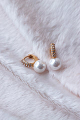 Details of a pair of elegant pearl hoop earrings