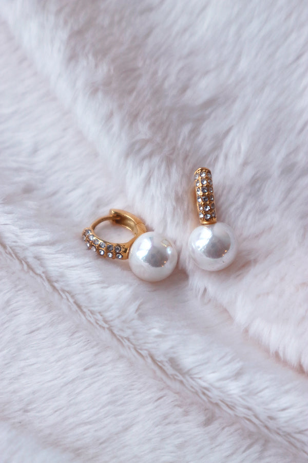 Details of a pair of elegant pearl hoop earrings