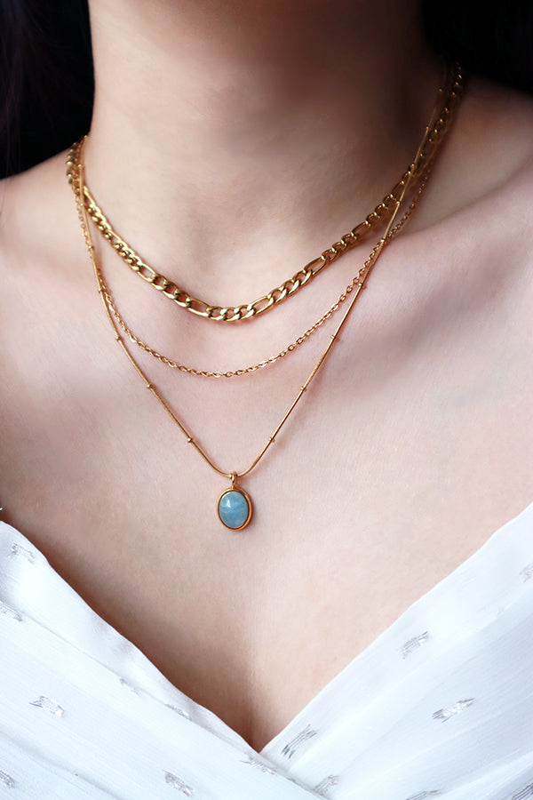 Asian model wearing gold plated layered necklace