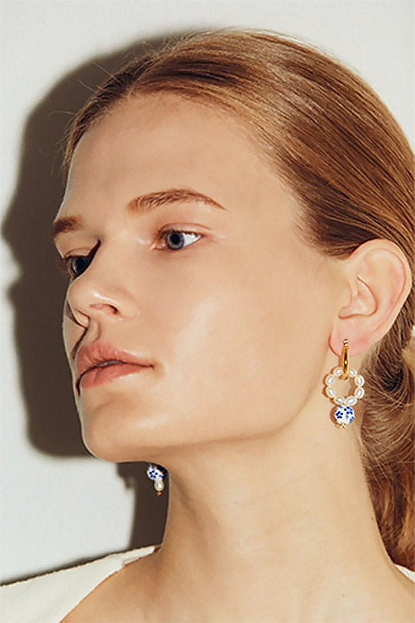 Caucasian model wearing oriental earrings